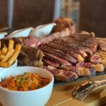 ¡Qué emocionante que hayáis visitado Andorra! 😊 Es un país con una belleza natural impresionante y una rica tradición gastronómica. El Restaurant La Sangría Grill suena como un lugar increíble para los amantes de la carne. Aquí tienes más detalles sobre este restaurante: Nombre: Restaurant La Sangría Grill Especialidad: Txuletones y carnes prémium XXXXL Ubicación: En la Carretera General, cerca de la rotonda de acceso al Santuario de Meritxell en Canillo. Los Chuletones son chuletas de carne de vacuno, típicas del País Vasco y Navarra. Se caracterizan por su gran tamaño y su sabor intenso. Si os gustan las carnes jugosas y sabrosas, seguro que disfrutasteis de una experiencia culinaria memorable en La Sangría Grill. Además, me alegra saber que seguís a @AndorraLovers. ¿Hay algún otro lugar o restaurante que hayáis descubierto durante vuestro viaje? Si tenéis más recomendaciones o si necesitáis información adicional sobre Andorra, no dudéis en preguntar. ¡Estoy aquí para ayudar! 😊🍽️ Havíem sentit molt a parlar del restaurant La Sangria Grill a Meritxell direcció Canillo i ja entenem el perquè. Restaurant La Sangria Grill esta situat a Meritxell, a uns 20 minuts d'Andorra la Vella. Està especialitzat en carn a la brasa a l'estil francès, de mida XXXXL, hi podeu trobar tomahawok o baveta de bou de diferents mides, la ració més petita es increiblement gran. Però la carta és molt variada i podeu trobar tota mena de plats típics de muntanya, i alguns de gastronomia francesa com fondues. Vam menjar molt i no ens va quedar gana per les postres, però diuen que s'han de provar les creps casilanes que fan. Si sou amants de la bona i millor carn, La Sangria Grill REstaurant és l'ideal per vosaltres! El plat més popular al Restaurant La Sangria Grill és, sens dubte, la carn a la brasa. Amb la seva especialització en carn a l’estil francès, és el lloc ideal per als amants de la bona i millor carn. Els tomahawks i les bavettes de bou són opcions delicioses, i la mida XXXXL de les racions segurament satisfarà fins i tot els més famolencs. A més, si us agraden els plats típics de muntanya i la gastronomia francesa, també podeu gaudir de fondues i altres opcions delicioses. I no oblideu deixar espai per les creps casolanes per a les postres! 😊 Si teniu més dubtes o necessiteu més informació, no dubteu a preguntar! 🍽️ Aquest cap de setmana hem estat a 📌 #Andorra al Restaurant La Sangria Grill a Meritxell on mana la cuina de muntanya🏔 amb plats molt abundants i les brases🔥 com a protagonistes a la cuina. Amb aquest escenari, vam decidir anar forts i anar a menjar un autèntic Xuleton de bou🥩 per dues persones només apte per carnívors amb gana😂 El restaurant escollit per fer aquest tros d’àpat va ser @lasangriacanillo, un local acollidor a les portes del Santuari de Meritxell. El mestre braser domina el foc amb mestratge👌🏻. Ens van servir el Xuleton XXXXL amb patates, verdura i acompanyat de 4 salses😍: pebre, ceps, formatge blau i all i julivert, d'escàndol😋, senzillament meravellós. Com que som uns temeraris, no vam poder evitar partir-nos un camembert🧀 fos al forn d’entrant🙊. Deliciós! Tot i que prescindible si haguéssim sabut el que ens venia després🤣 🍷: un vi negre Ales Negres de l’Empordà del celler @terraremota 100% garnatxa negra que va ser el company de festa pel festival de carn. #foodielophia #foodporn #foodie #andorrafoodie #instafood #foodart #instagood #chuletón #txuletón #meat #meatlovers #lasangriagrill #lasangria #andorra #andorre #meritxell #canillo #restaurantesandorra #andorrarestaurantes Sembla que heu tingut una experiència gastronòmica increïble al Restaurant La Sangria Grill! El fet que el restaurant estigui situat a Meritxell, prop del Santuari de Meritxell, li dona un toc especial. I, per descomptat, la carn a la brasa és la protagonista indiscutible. El Xuleton de bou que vau demanar sembla una autèntica festa per als amants de la carn. Amb les patates, la verdura i les 4 salses (pebre, ceps, formatge blau i all i julivert), segurament va ser una experiència deliciosa. I no puc evitar somriure amb la vostra descripció del camembert al forn d’entrant. A vegades, les sorpreses culinàries són les millors! El vi negre Ales Negres de l’Empordà sembla una excel·lent elecció per acompanyar aquest festival de carn. La garnatxa negra segurament va realçar els sabors i va fer que l’àpat fos encara més memorable. Gràcies per compartir aquesta història amb mi! Si teniu més dubtes o necessiteu més recomanacions, no dubteu a preguntar. Bon profit! 🍽️🔥🍷 ¡El nombre de este restaurante no hace justicia a lo BIEN que se come allí, y es que además, tienen opciones #singluten en muchos de sus platos! 🌾 En mi caso me pedí de primero un queso Camembert fundido con miel, nueces y pasas y el pan que lo acompañaba era #singluten 🍞 ¡Sus especialidades son las carnes 🤤 así que si sois amantes de la comida de montaña, os recomiendo ir a este restaurante en Andorra! Pd: lo único que me decepcionó un poco es que no tenían cerveza #singluten 🍺 ¡De todas formas se lo comenté así que quizás para la próxima ya tengan! 🚀 #singluten #glutenfree #glutenfreebarcelona #singlutenbarcelona #celiacos #celiacs #celiacosespaña #celiacscatalunya #sensegluten #senseglutenbarcelona #senseglutenandorra #singlutenandorra Weekend in Andorra! We have decided to spend some days in Andorra and it was really relaxing and good to recharge our batteries! We have tried to find new restaurants and @lasangriacanillo has been a really good surprise. Very nice service, high quality food and a really good Portuguese wine from @adegamayor Reserva 2018. Rated in @vivino with 4.2 (we always use this app to support us in choosing the wine) was really a good surprise! Very acceptable price and really good quality. We truly recommend it! #andorra #ski #andorrarestaurants #lasangriacanillo #adegamayor #portuguesewine #alentejo #foodtravelandllove